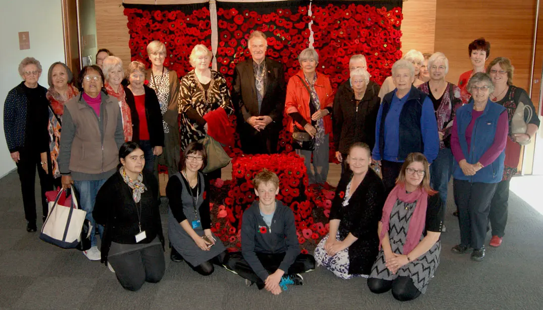 Image of staff and others who made poppies for 2721 Poppies exhibit